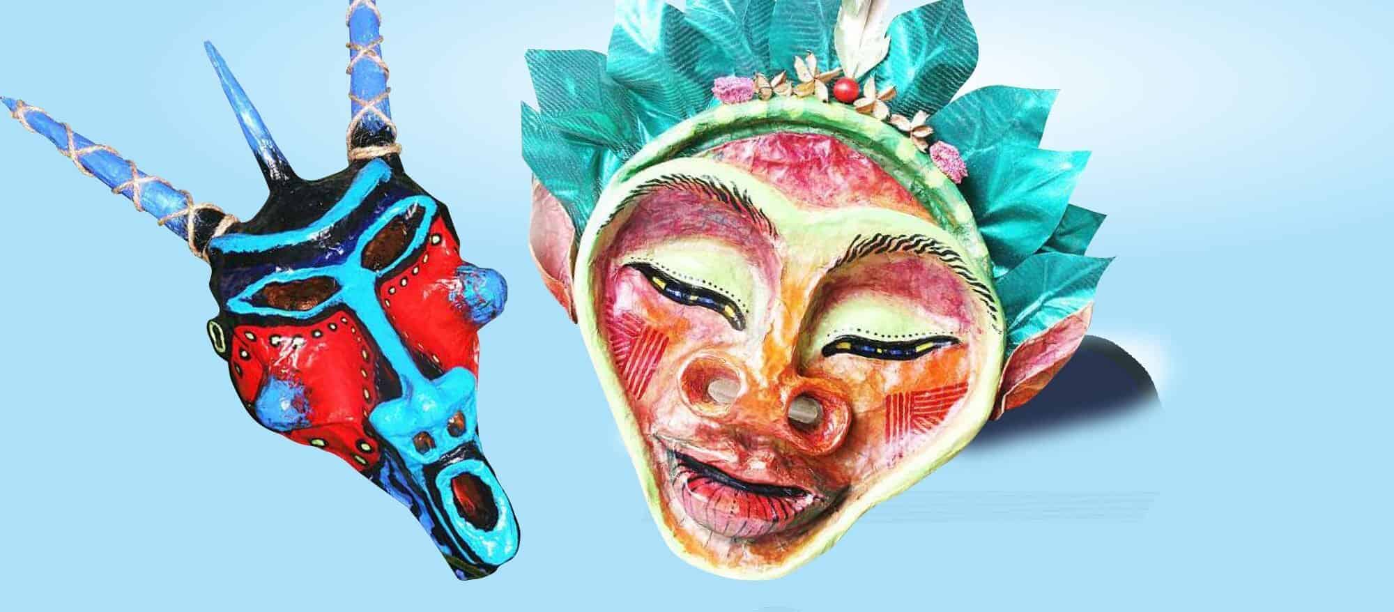 Two colourful masks are displayed against a light blue background; one resembles an animal with horns, and the other is a human face with closed eyes and green headdress.